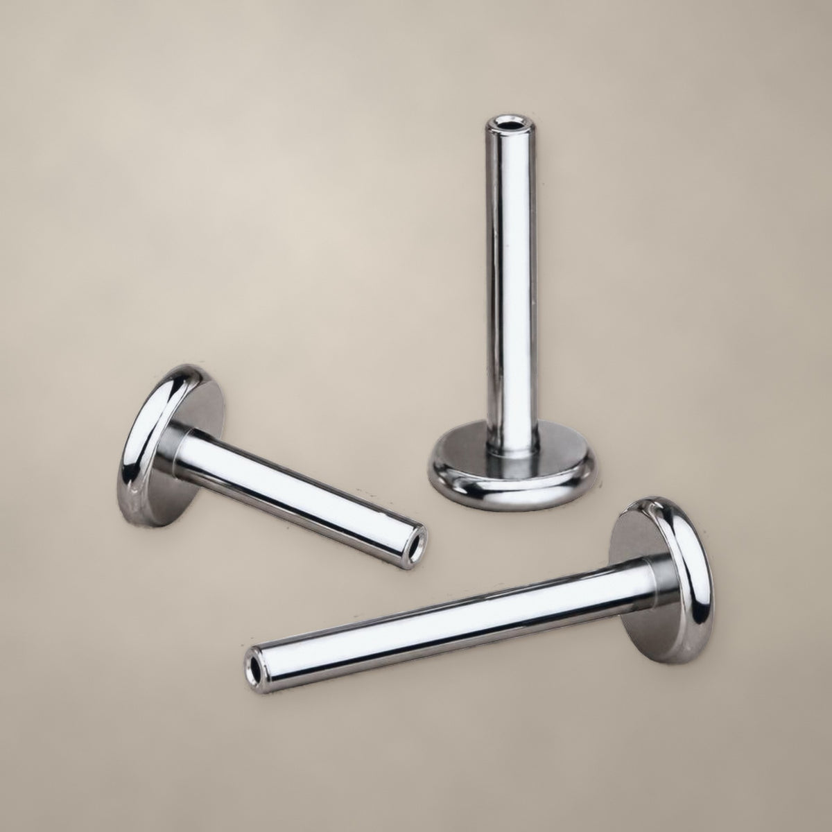 Titanium internally threaded labret post with flat back, three posts shown
