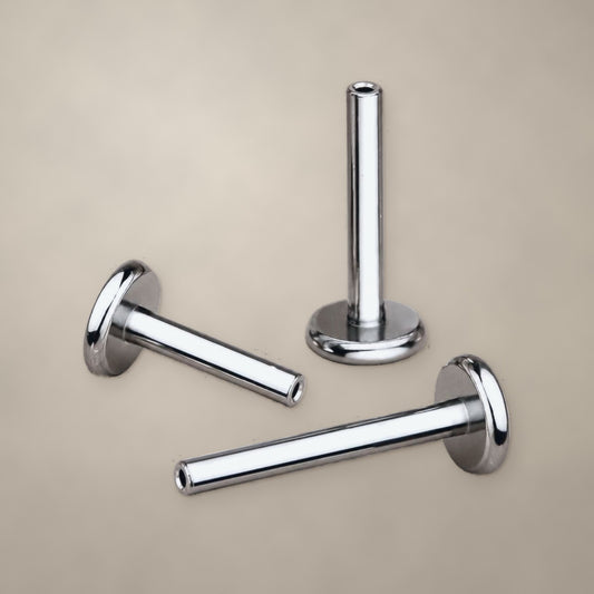 Titanium internally threaded labret post with flat back, three posts shown