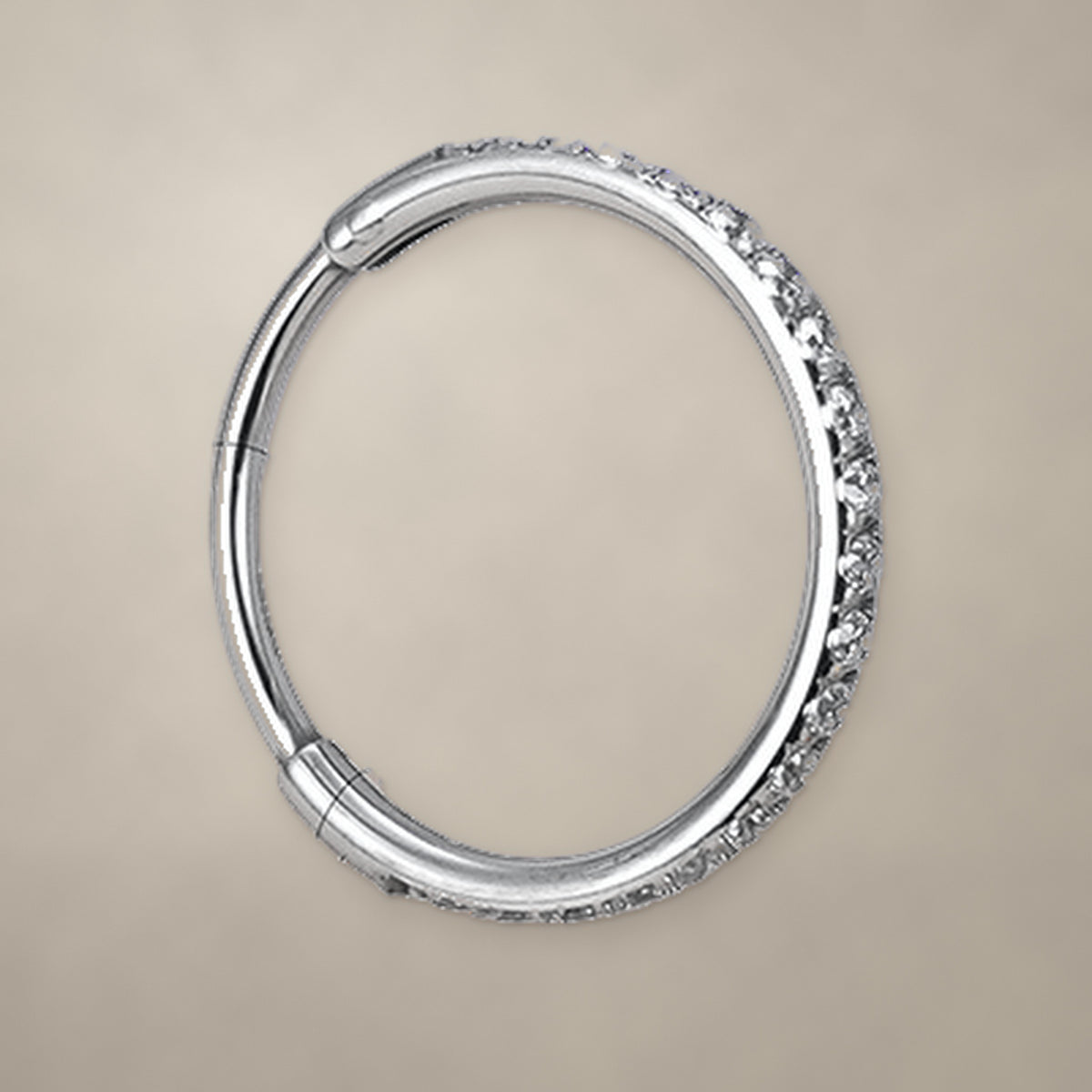 Titanium hinged clicker ring with clear CZ stones set along the front of the band