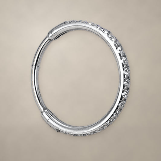 Titanium hinged clicker ring with clear CZ stones set along the front of the band