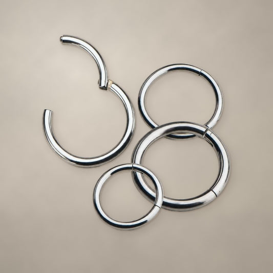 Classic titanium clicker ring, shown in four sizes