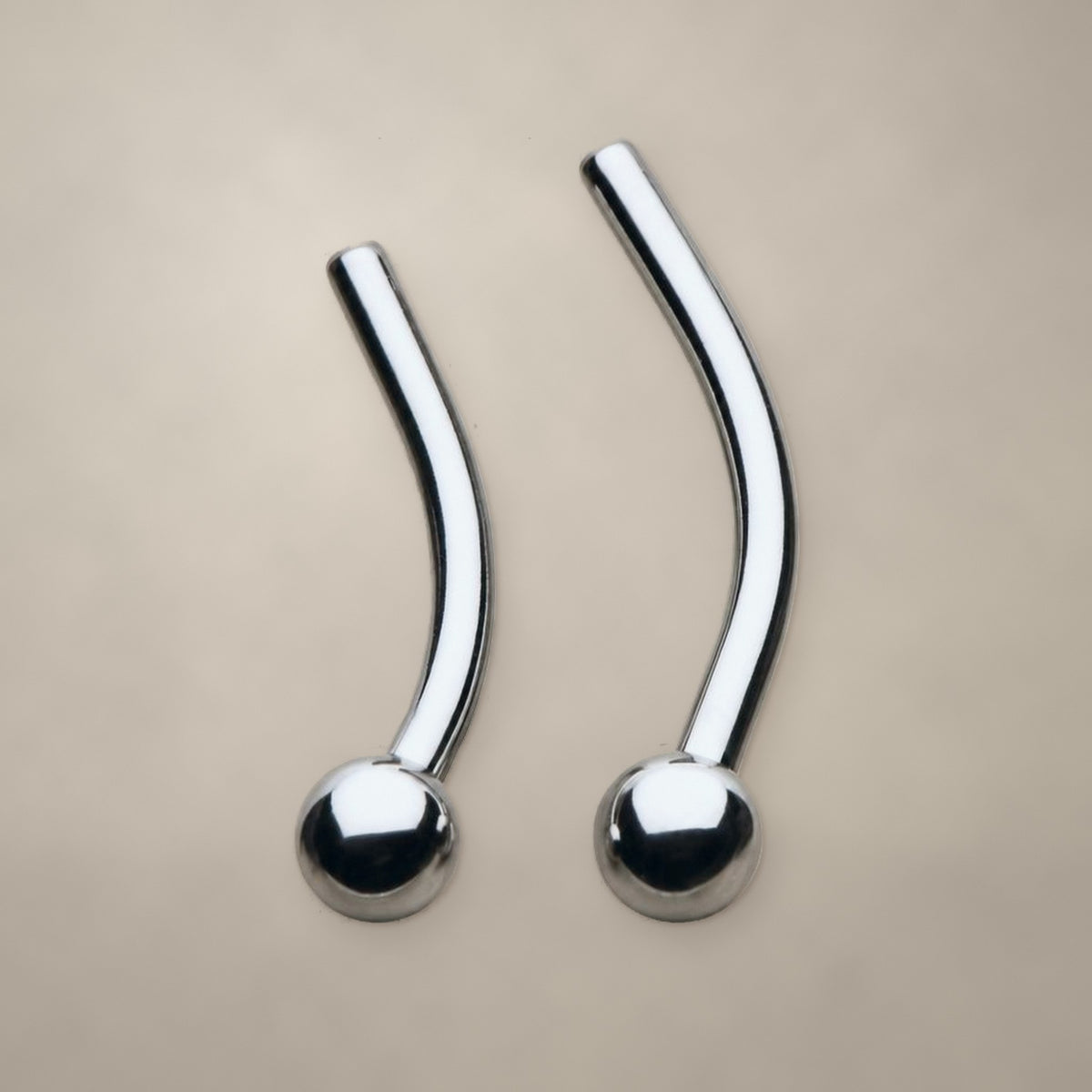 Ball-end threadless curved barbell in titanium, shown from two angles