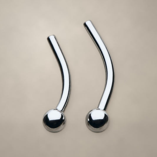 Ball-end threadless curved barbell in titanium, shown from two angles