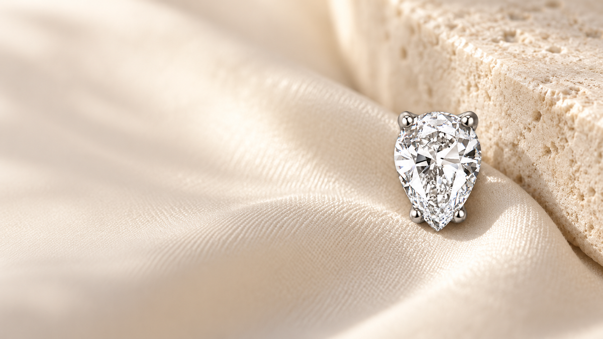 Pear-shaped Belmont jewelry on ivory silk